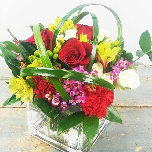 All Delight Bouquet with red roses Peruvian lilies waxflowers hypericum berries in glass cube vase