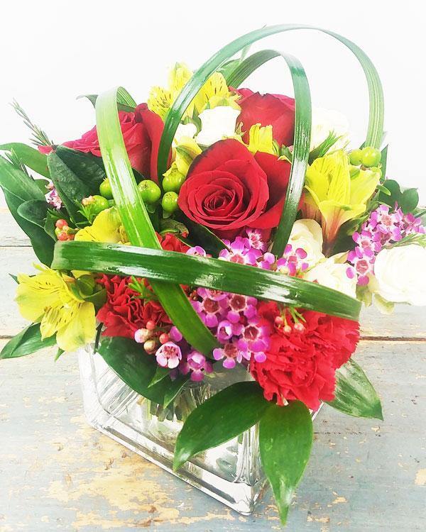 All Delight Bouquet with red roses Peruvian lilies waxflowers hypericum berries in glass cube vase