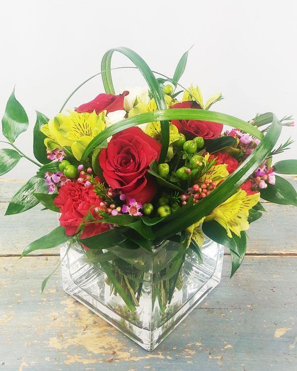 All Delight Bouquet with red roses Peruvian lilies waxflowers hypericum berries in glass cube vase