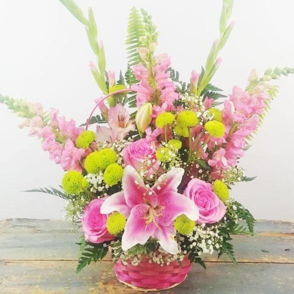 Blushes of Pink Basket with pink lilies roses snapdragons gladiolus green poms baby’s breath.