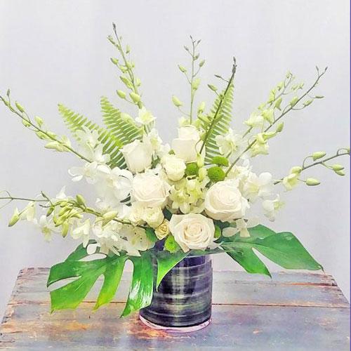Elegant sympathy bouquet with assorted fresh flowers arranged in a vase