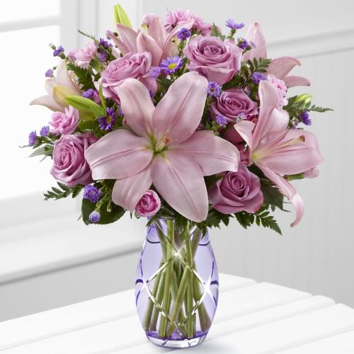 A stunning floral arrangement featuring elegant lavender roses and vibrant pink Asiatic lilies.