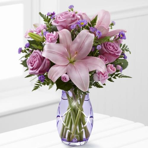 A stunning floral arrangement featuring elegant lavender roses and vibrant pink Asiatic lilies.