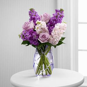 The Sweet Devotion Bouquet -  Lavender roses and purple stock flowers in a purple glass vase.