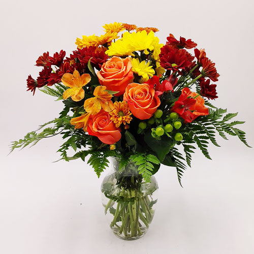 Autumn Serenade Bouquet in clear glass vase with vibrant fall flower