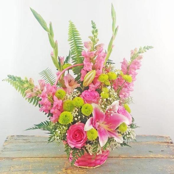 Blushes of Pink Basket with pink lilies roses snapdragons gladiolus green poms baby’s breath.
