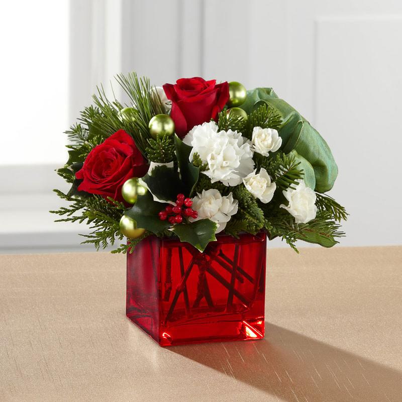 Merry & Bright Bouquet with red roses, white carnations, holly and Christmas greens accented with green glass ornaments in a red cube vase – Toronto holiday flower delivery